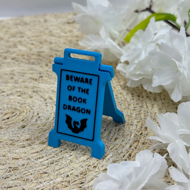 'beware of the book dragon' sign