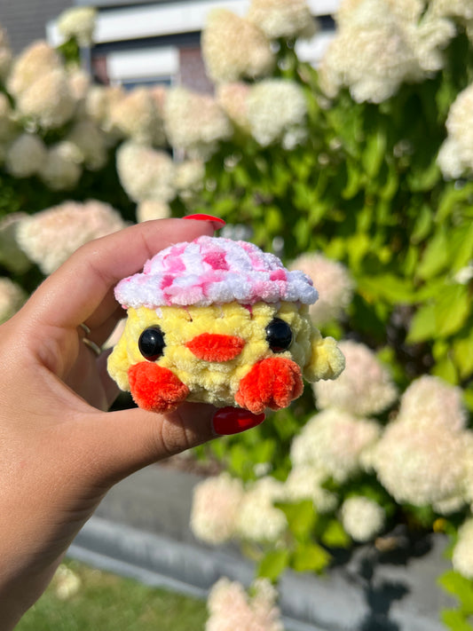 kuiken met roze confetti hoed